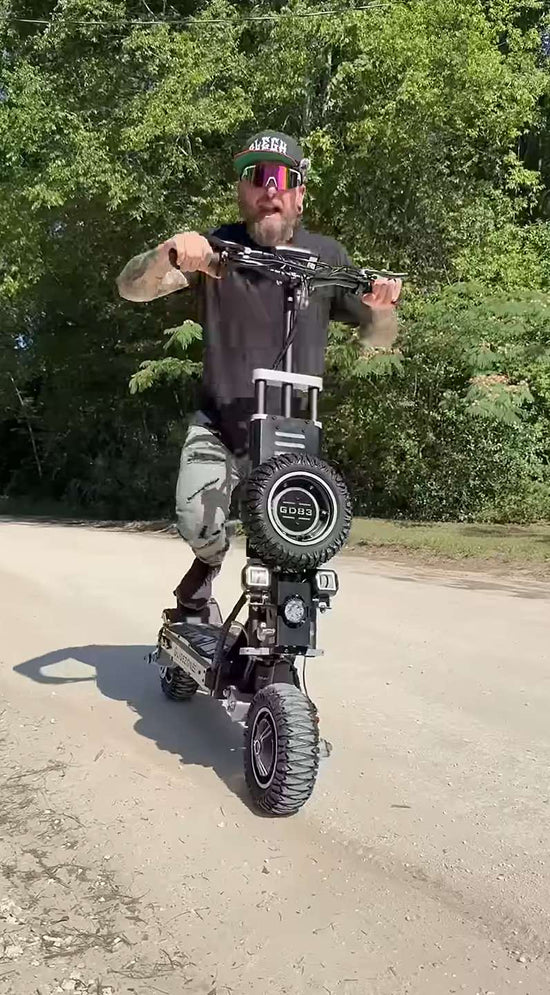 Hero image for the ultimate guide to the Glidezone GD83 electric scooter, featuring an adult male rider standing on the deck to show its heavy-duty build.