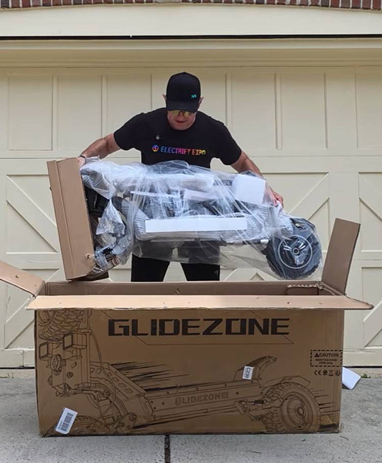 Unboxing the Glidezone GD83 dual motor electric scooter out of its original shipping box.