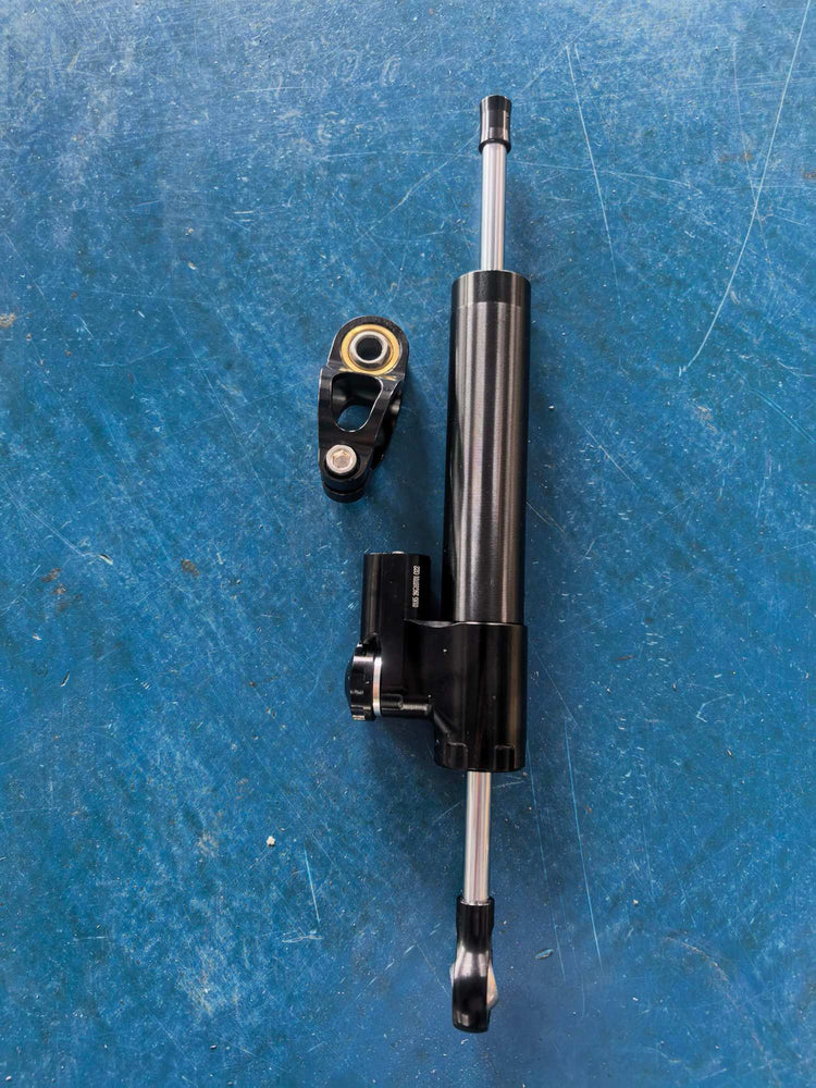 Rooder steering damper kit for Glidezone GD83 electric scooter with black adjustable shock body and mounting clamp.